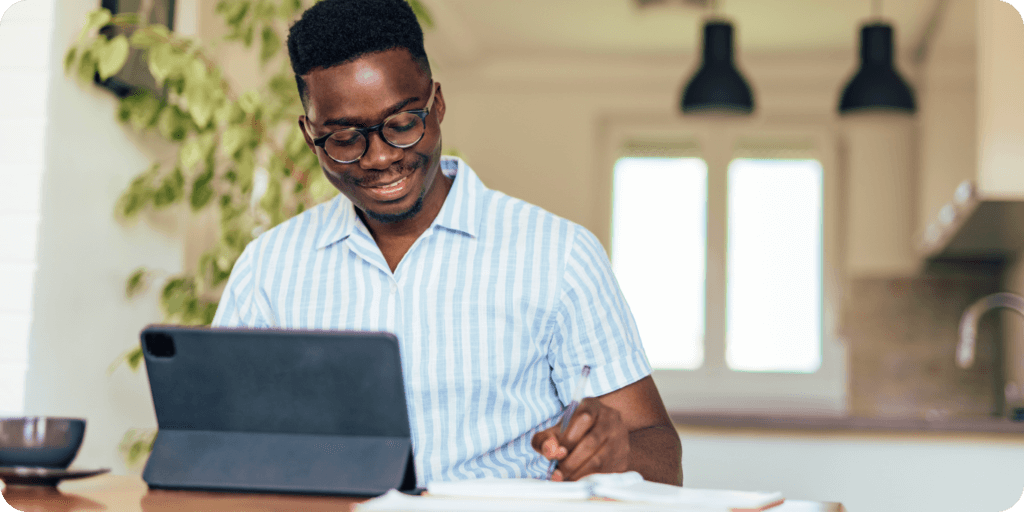 man sitting at a table filing his taxes