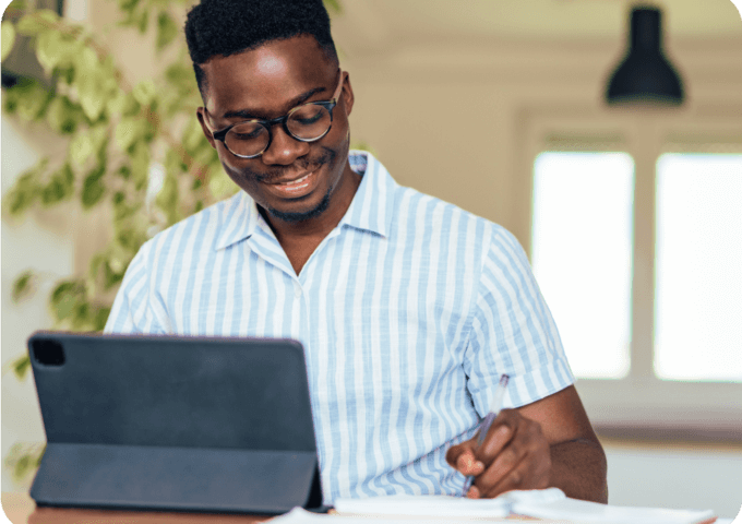 man sitting at a table filing his taxes